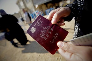A Syrian woman shows her passeport as families, who fled recent violence in the mountainous Qalamoun region, wait to be registered by the United Nations High Commissioner for Refugees (UNHCR) on November 19, 2013 in Arsal in the Lebanese Bekaa valley. The fighting in Qara in the Qalamoun region sent at least 1,700 families streaming across the border into Lebanon, which is already hosting more than 800,000 Syrian refugees and has suffered from rising unrest linked to the conflict in its larger neighbour. Syrian troops captured the village of Qara on November 19, 2013. AFP PHOTO/JOSEPH EID