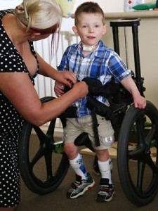 Lachlan Neylan suffered brain damage after being administered a fluvax vaccine which is banned in kids under 5, his parents Adrian and Stacey have turned their Sydney home into a rehab facility to help him learn to walk and talk again. Lachlan is strapped into his walker to help get him walking correctly again.