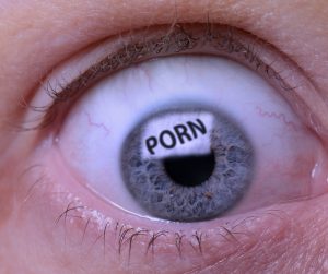 Concept of Porn addiction an eye looking at a screen of pornography